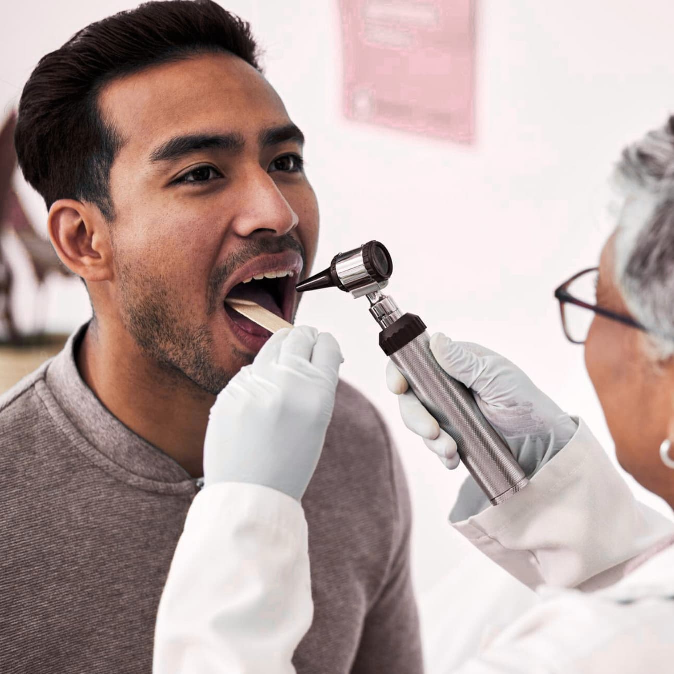 Dentist performing a thorough oral cancer screening at Rancho Bernardo Dental Arts